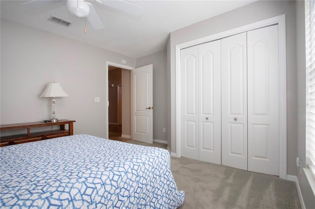 carpeted bedroom featuring visible vents, baseboards, a closet, and ceiling fan