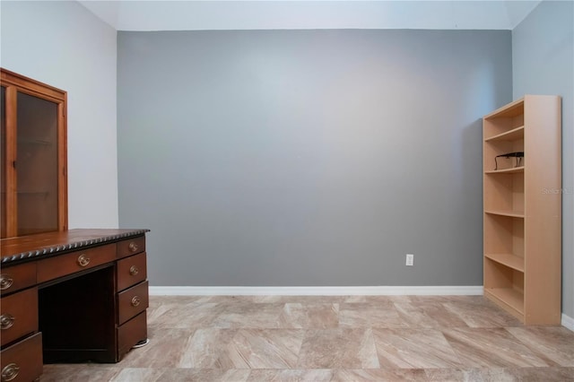 unfurnished office with baseboards