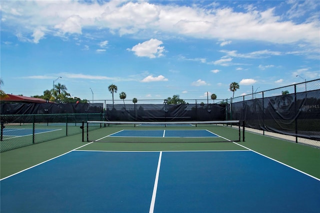 view of sport court featuring community basketball court and fence