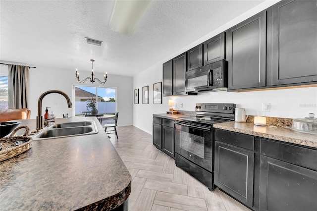 kitchen with black appliances, a sink, visible vents, and a healthy amount of sunlight