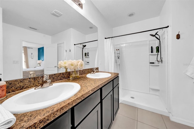 full bath with curtained shower, a sink, visible vents, and tile patterned floors