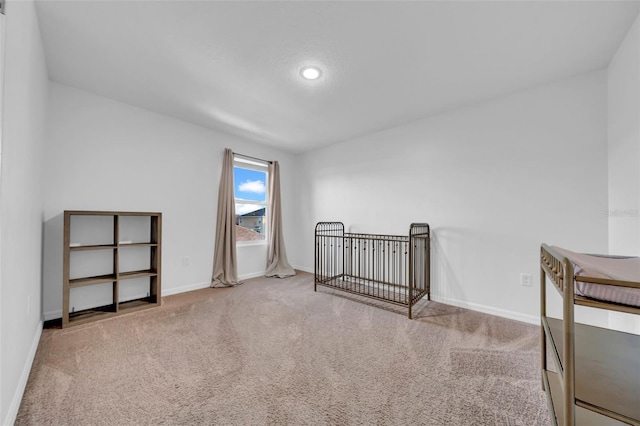 bedroom with carpet floors and baseboards