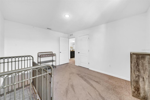 carpeted bedroom with visible vents and baseboards