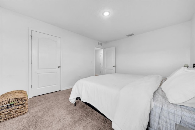 carpeted bedroom featuring visible vents