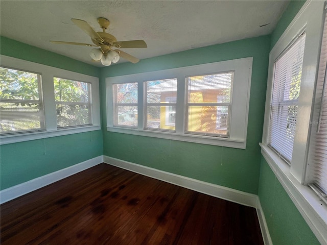 unfurnished sunroom with a wealth of natural light and ceiling fan