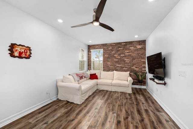 living area featuring recessed lighting, brick wall, wood finished floors, a ceiling fan, and baseboards