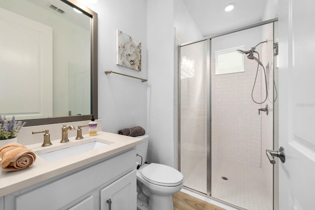 full bath with toilet, a stall shower, visible vents, and vanity