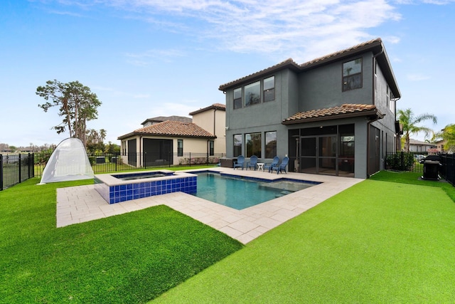 back of property with a tile roof, stucco siding, a lawn, a patio area, and a fenced backyard