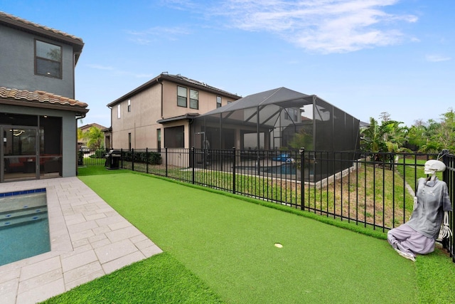 view of yard with glass enclosure, fence, a fenced in pool, and a patio