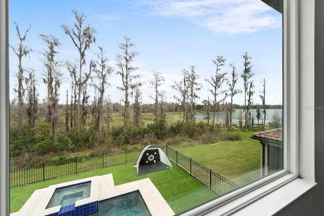 view of pool featuring a yard, a water view, a fenced backyard, and an in ground hot tub