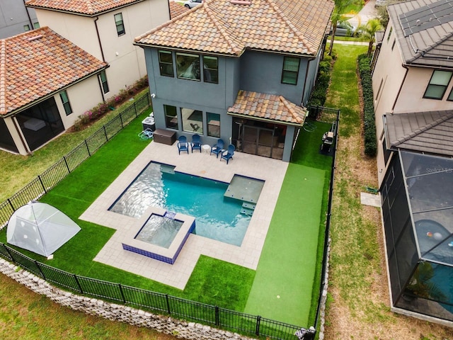 back of house with a yard, a patio, a tile roof, and a fenced backyard