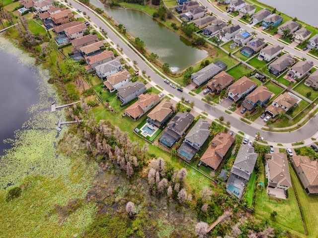 drone / aerial view with a water view and a residential view