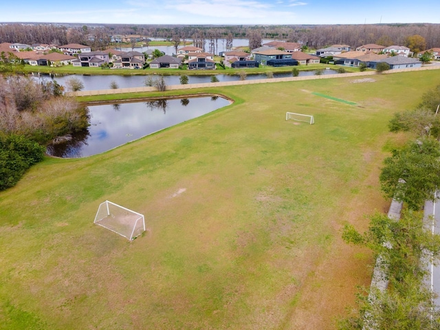 birds eye view of property with a water view and a residential view