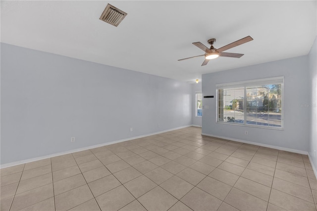 unfurnished room featuring ceiling fan, visible vents, and baseboards