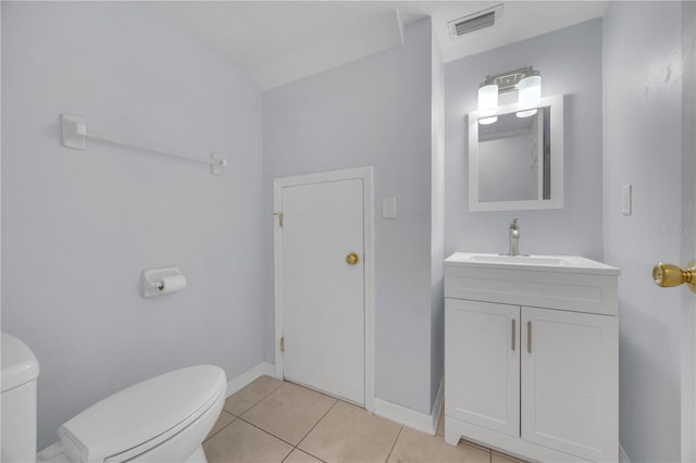 half bath with visible vents, baseboards, toilet, tile patterned flooring, and vanity