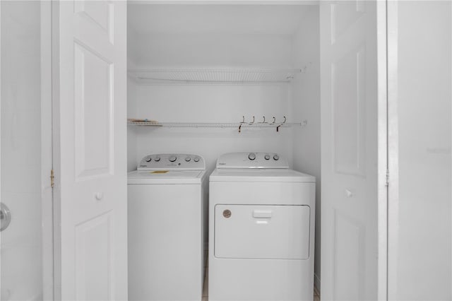 clothes washing area with laundry area and washer and dryer