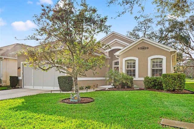 view of front facade with concrete driveway, a front lawn, an attached garage, and stucco siding