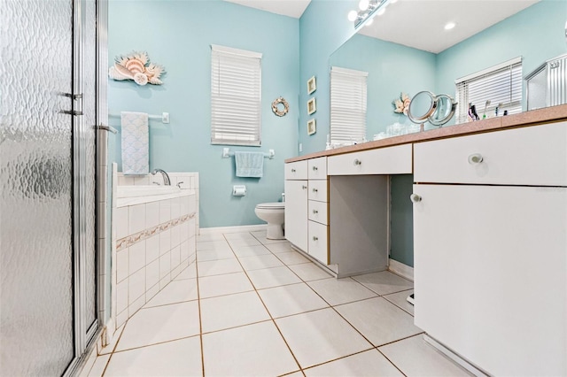 bathroom featuring a stall shower, vanity, toilet, and tile patterned floors