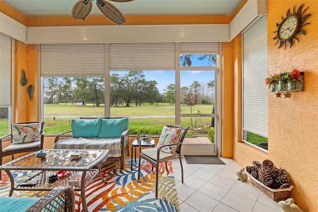 sunroom featuring a ceiling fan and a healthy amount of sunlight