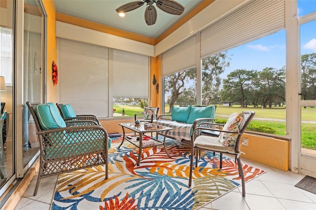 sunroom featuring a ceiling fan and a wealth of natural light