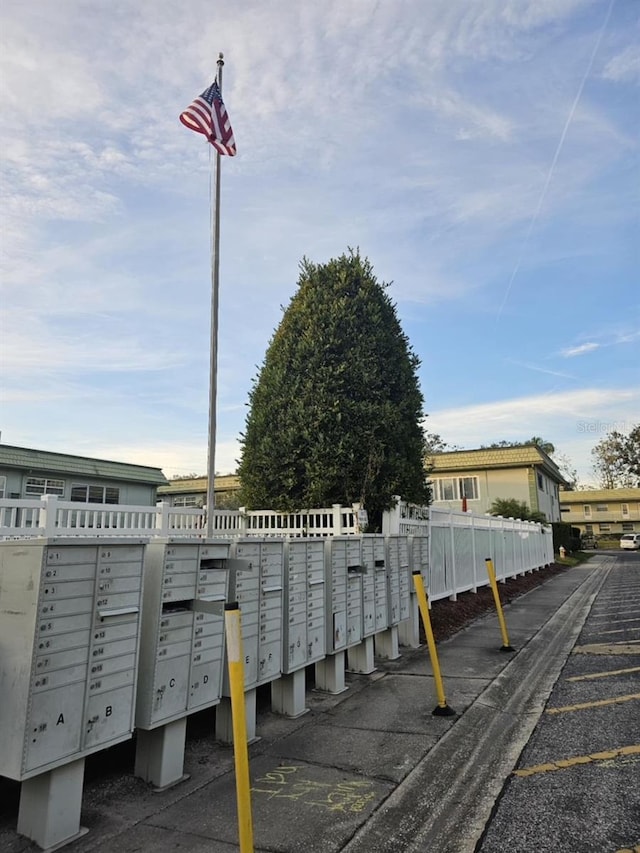 view of community featuring fence and mail area