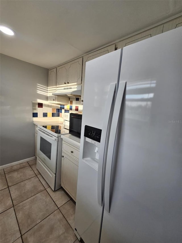 kitchen with white electric stove, light tile patterned floors, light countertops, fridge with ice dispenser, and under cabinet range hood