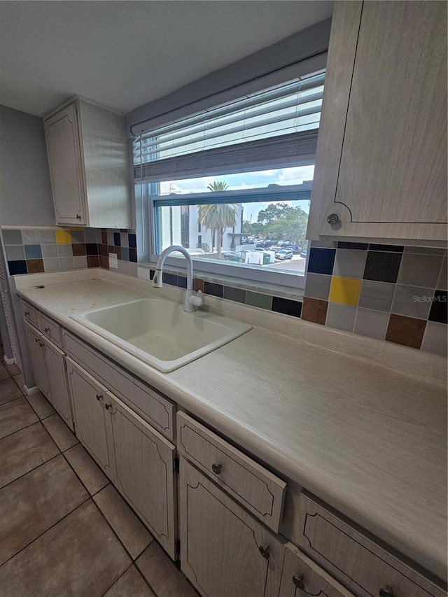 1433 S Belcher Rd Unit A12, Clearwater, FL 33764 - kitchen with a sink, plenty of natural light, tasteful backsplash, and light tile patterned floors