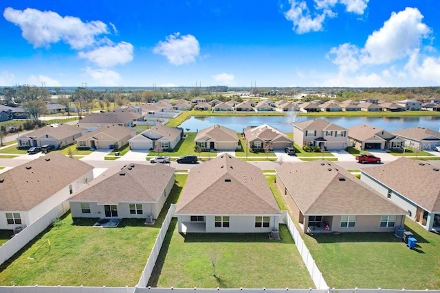 drone / aerial view with a residential view and a water view