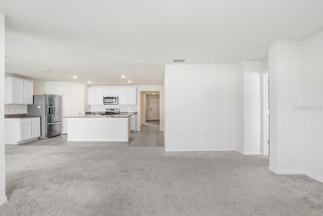 unfurnished living room with baseboards, recessed lighting, visible vents, and light colored carpet