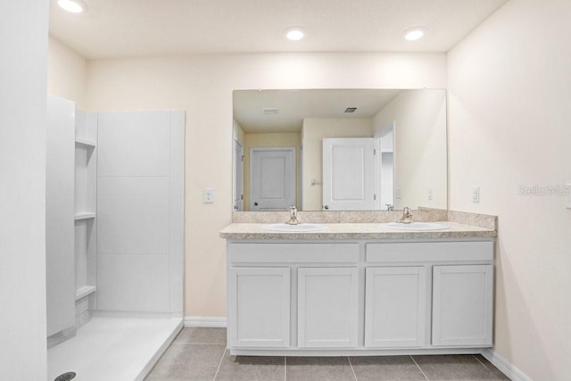 full bathroom with tile patterned flooring, a sink, and double vanity