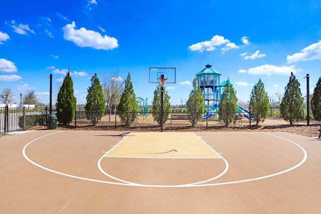 view of basketball court with community basketball court, fence, and playground community