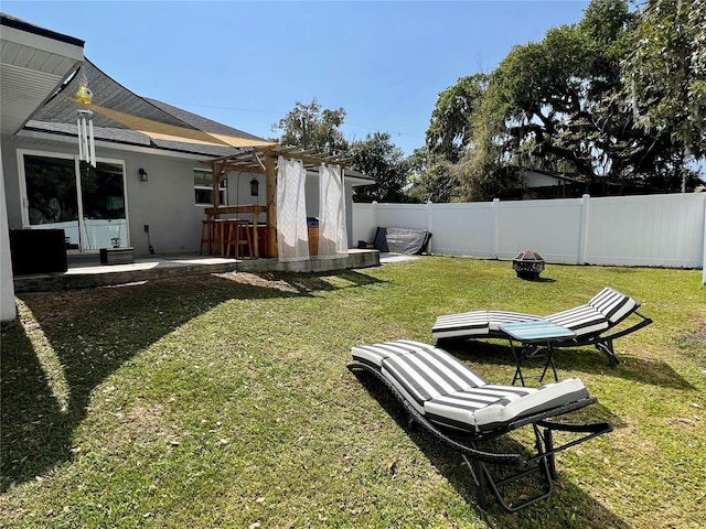 view of yard with a fenced backyard, a pergola, and a patio area