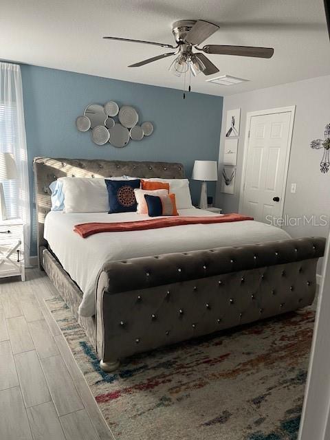 bedroom featuring ceiling fan and wood finish floors