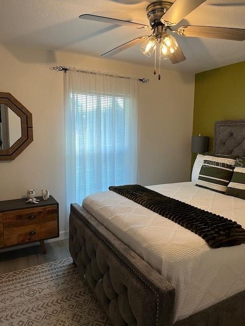 bedroom with wood finished floors and a ceiling fan