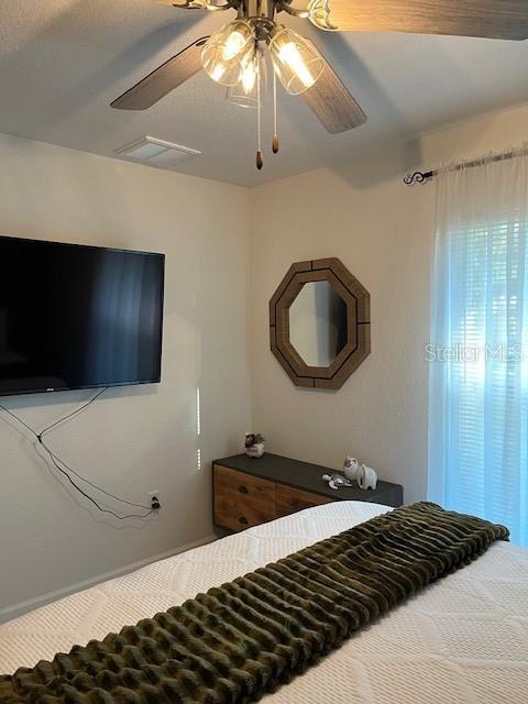 bedroom with visible vents and ceiling fan