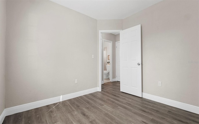 empty room with wood finished floors and baseboards