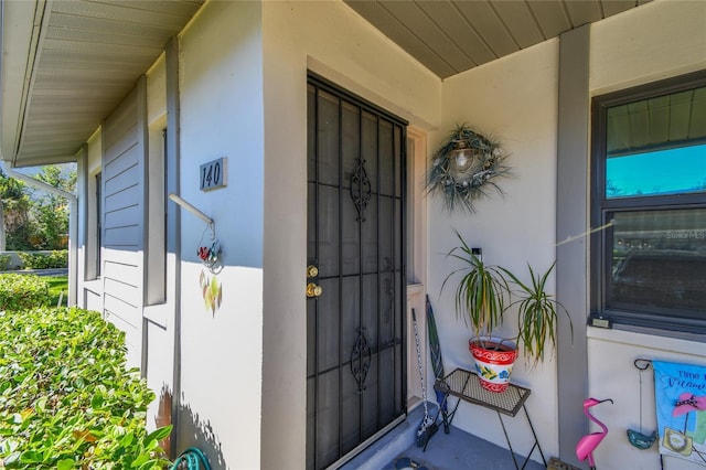 entrance to property with stucco siding