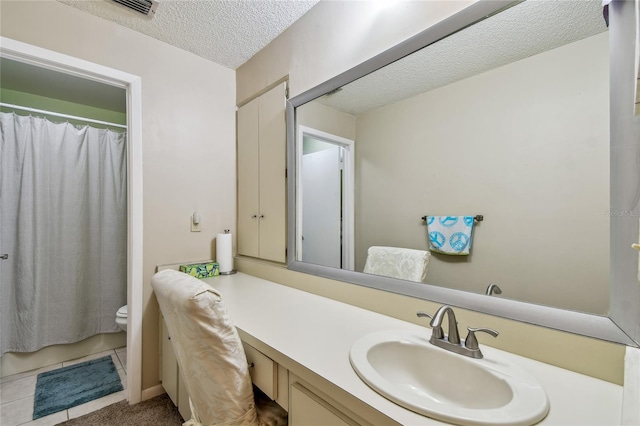 bathroom with toilet, a textured ceiling, a shower with shower curtain, tile patterned flooring, and vanity