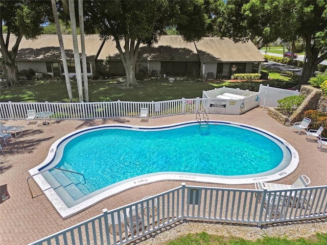 pool featuring a patio and fence