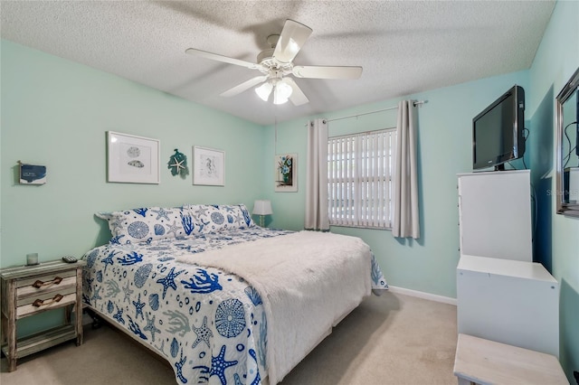 carpeted bedroom with baseboards, a textured ceiling, and a ceiling fan