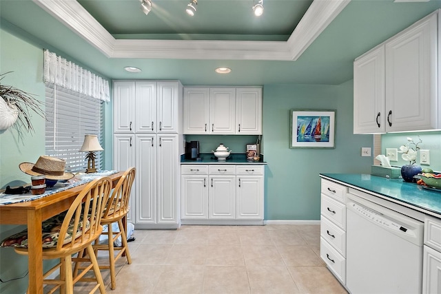 kitchen with dishwasher, a tray ceiling, light tile patterned floors, and white cabinets