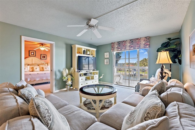 carpeted living area featuring ceiling fan, a textured ceiling, and baseboards