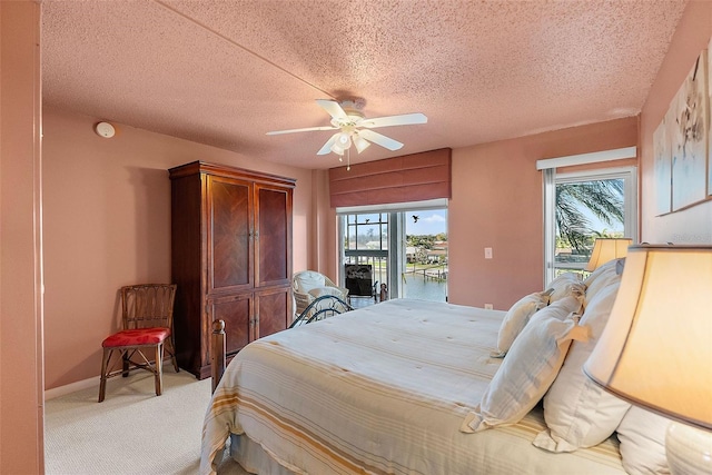 bedroom featuring light carpet, ceiling fan, multiple windows, and access to exterior