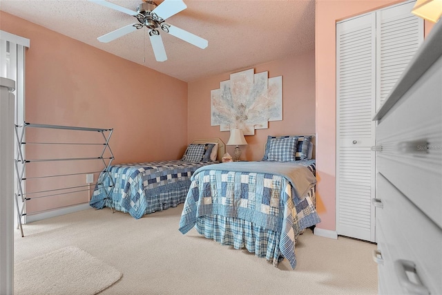 bedroom with a closet, carpet flooring, vaulted ceiling, and a textured ceiling