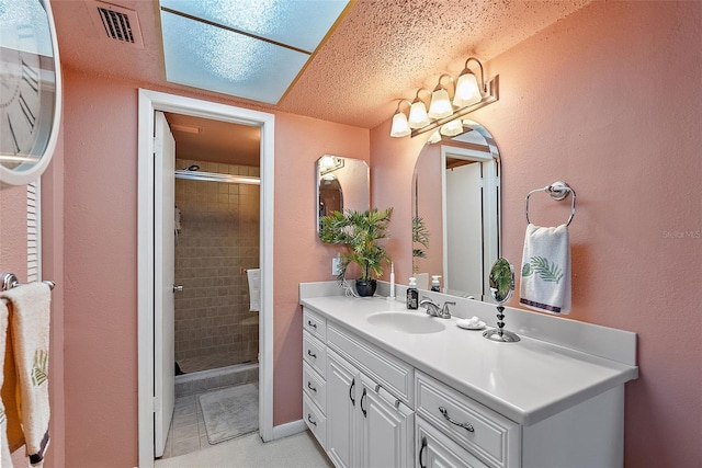 full bath featuring a stall shower, visible vents, and vanity