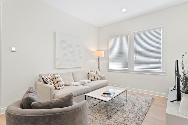 living room with recessed lighting, baseboards, and light wood finished floors