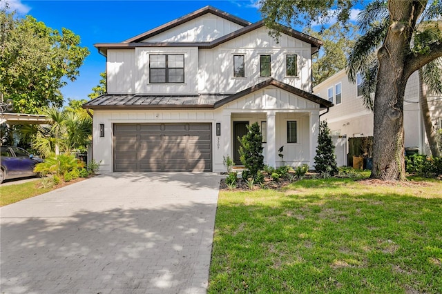 3618 W Royal Palm Cir, Tampa, FL 33629 - view of front of property with driveway, a front lawn, a garage, a standing seam roof, and board and batten siding