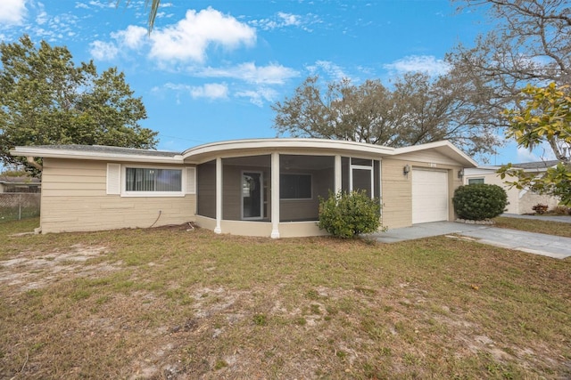 ranch-style house with concrete driveway, a front lawn, an attached garage, and a sunroom