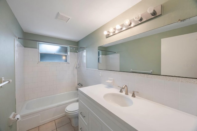 full bathroom with tile patterned flooring, visible vents, vanity, bathing tub / shower combination, and tile walls