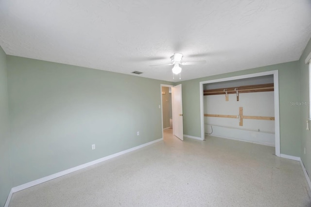 unfurnished bedroom with light speckled floor, a closet, visible vents, and baseboards